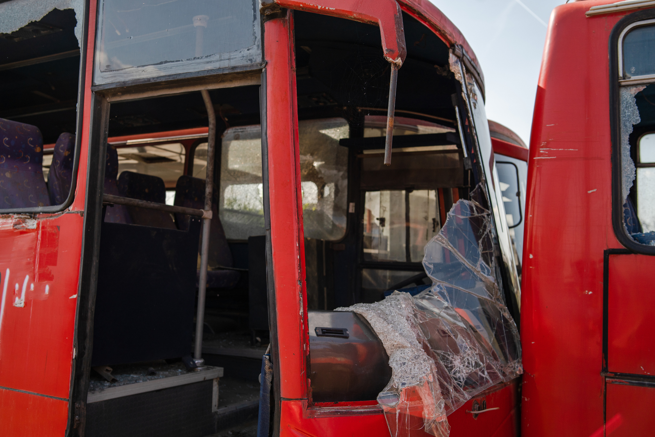 Bus collision crush traffic accident broken wrecked buses with smashed windshield shredded glass ready for scrap junk