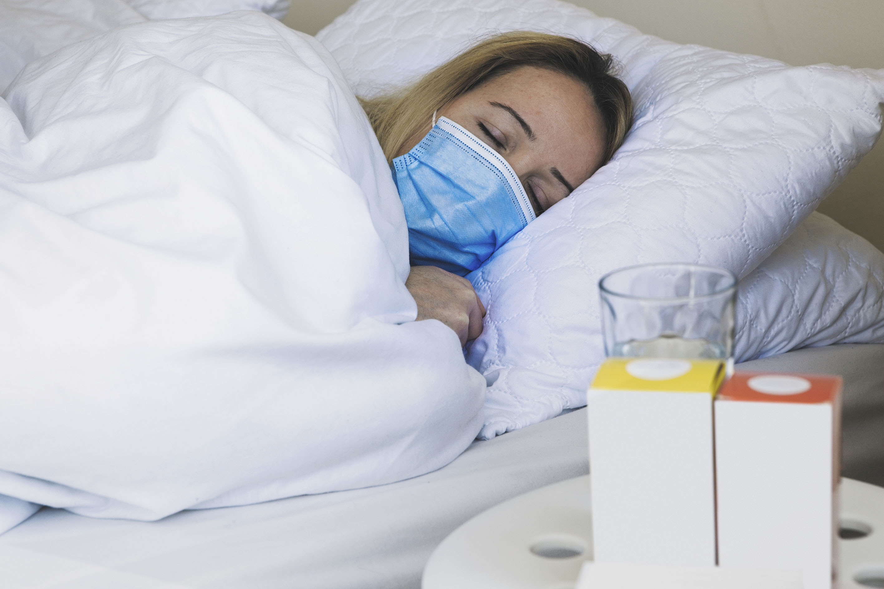 Woman coughing and suffering in medical mask inside the home bedroom, illness and fever concept, Measuring fever