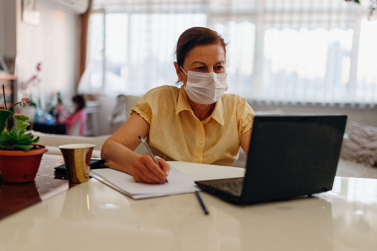 senior woman  working on laptop at home