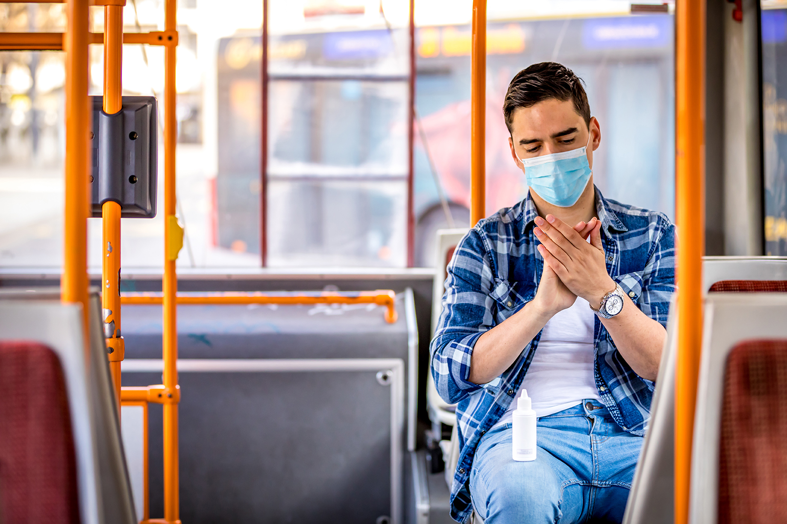 Image of  man in bus wearing medical face mask to protect coronavirus Covid-19 virus, pollution, face masks travelling during global health emergency, bird flu, respiratory problem, viral pneumonia, SARS, illnesses, quarantine and diseases