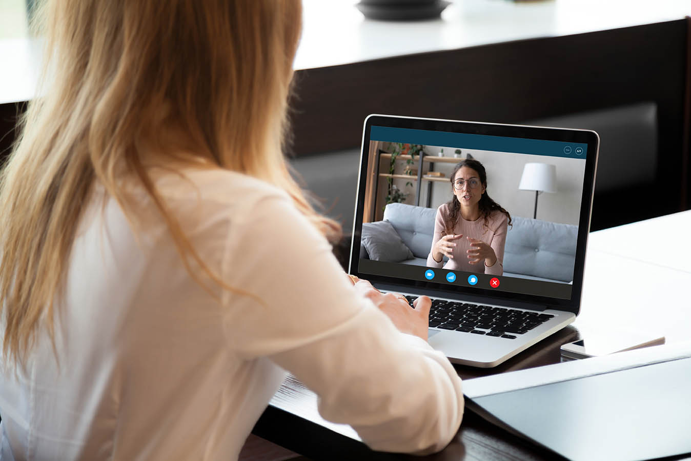 Young girl student woman holding educational video call with teacher on computer, learning foreign language online from home, using videoconference application, chat communicate distantly with friend.