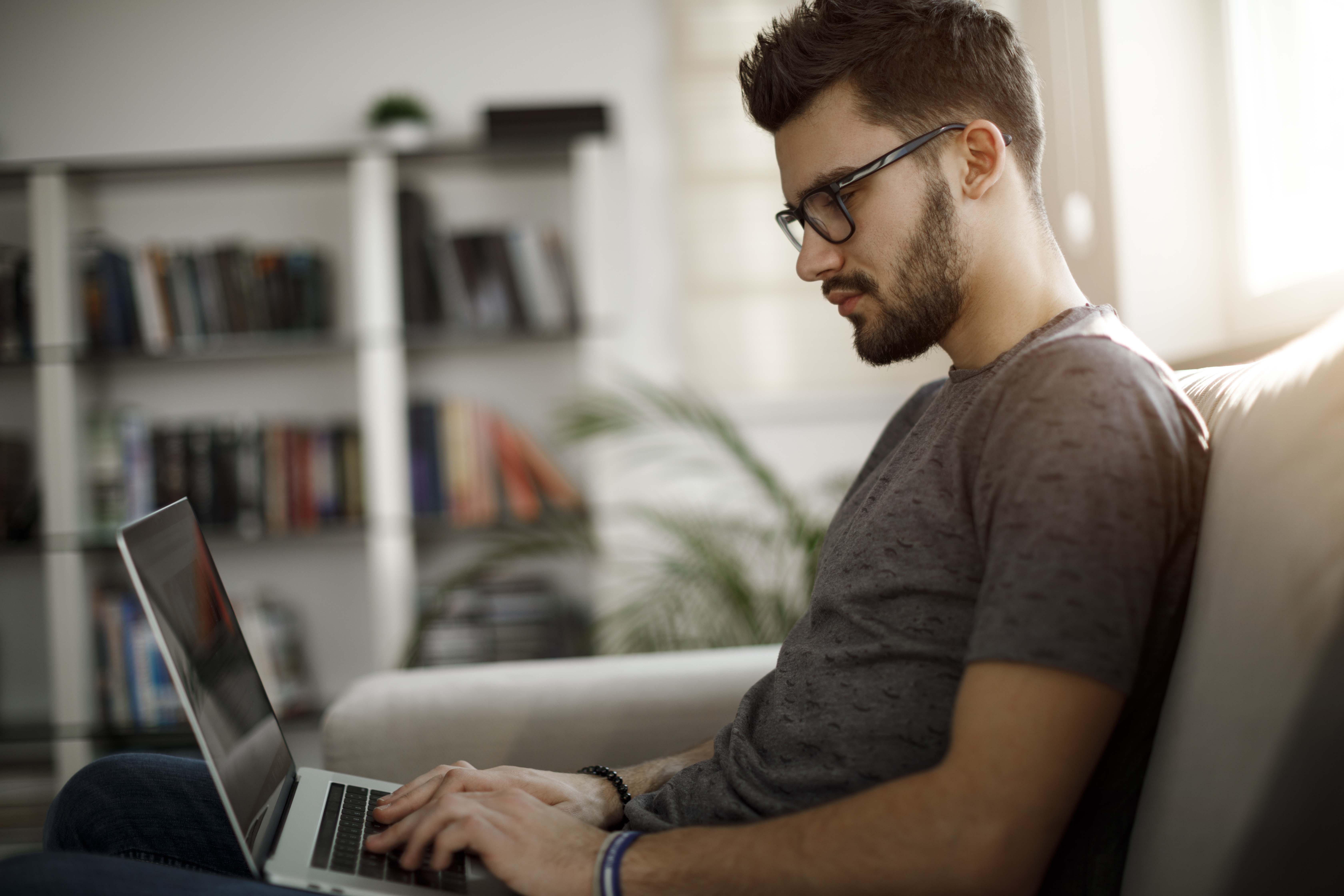 Young man using laptop at home