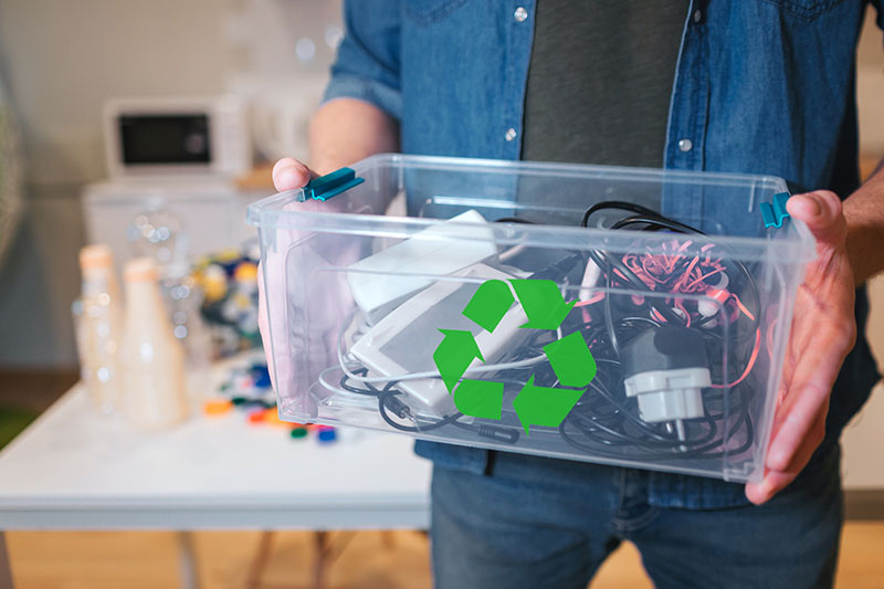 Ecology concept. An electronic colofrul waste in recycling contaner close-up. Responsible man is protecting environment while sorting the waste at home