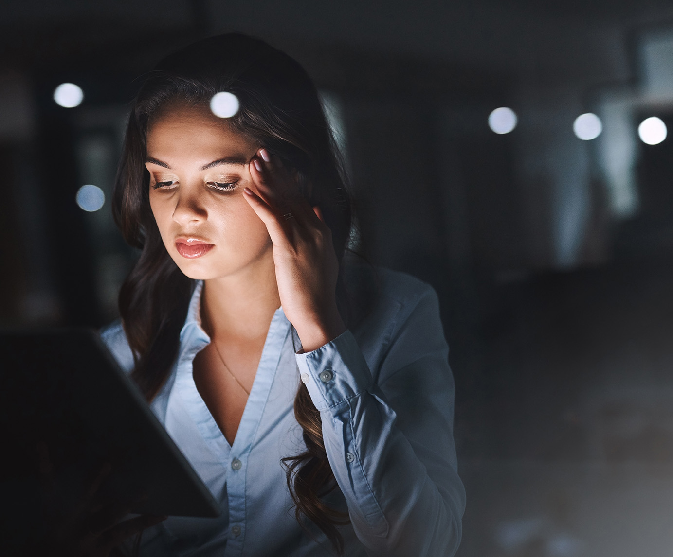 Cropped shot of an attractive young businesswoman looking stressed while working on her tablet late in the office