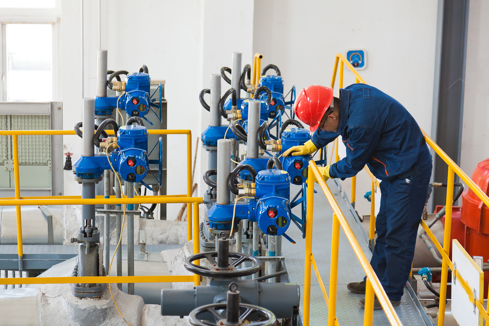 Engineer checking the oil pipeline equipment in crude oil storage workshop, Beijing, China.