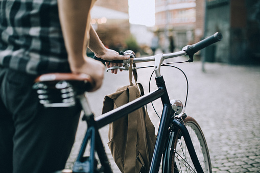 Man leading his bike through the city