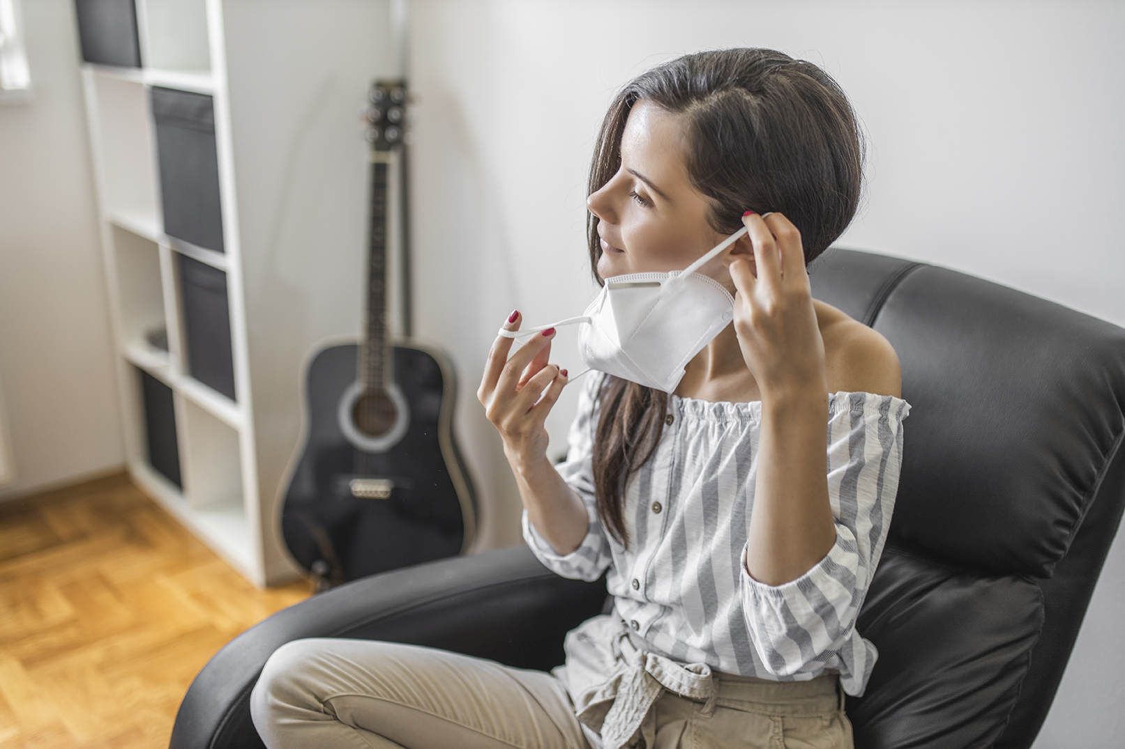 Portrait of young woman putting on a protective mask for coronavirus isolation