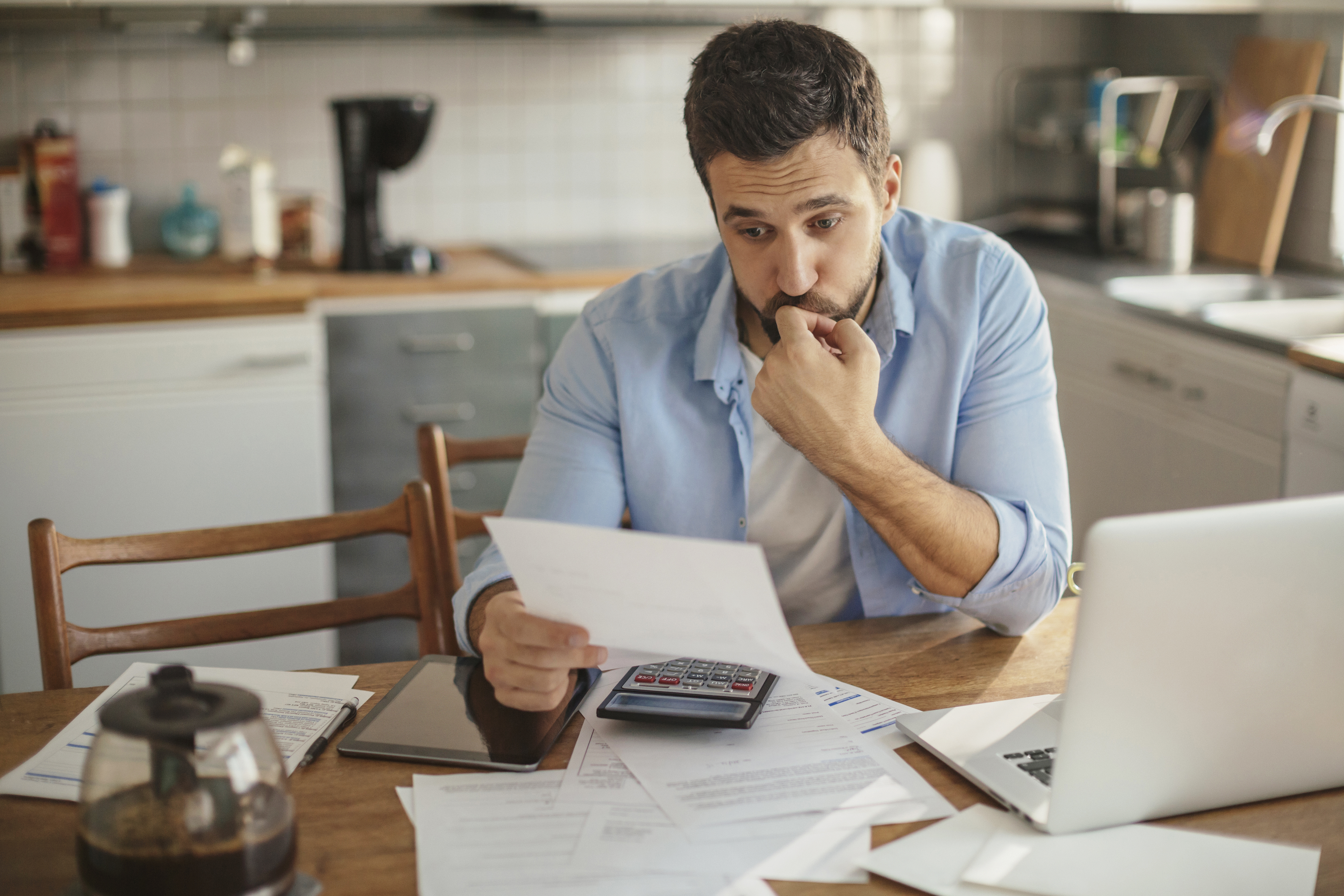 Photo of a man going through his financials problems