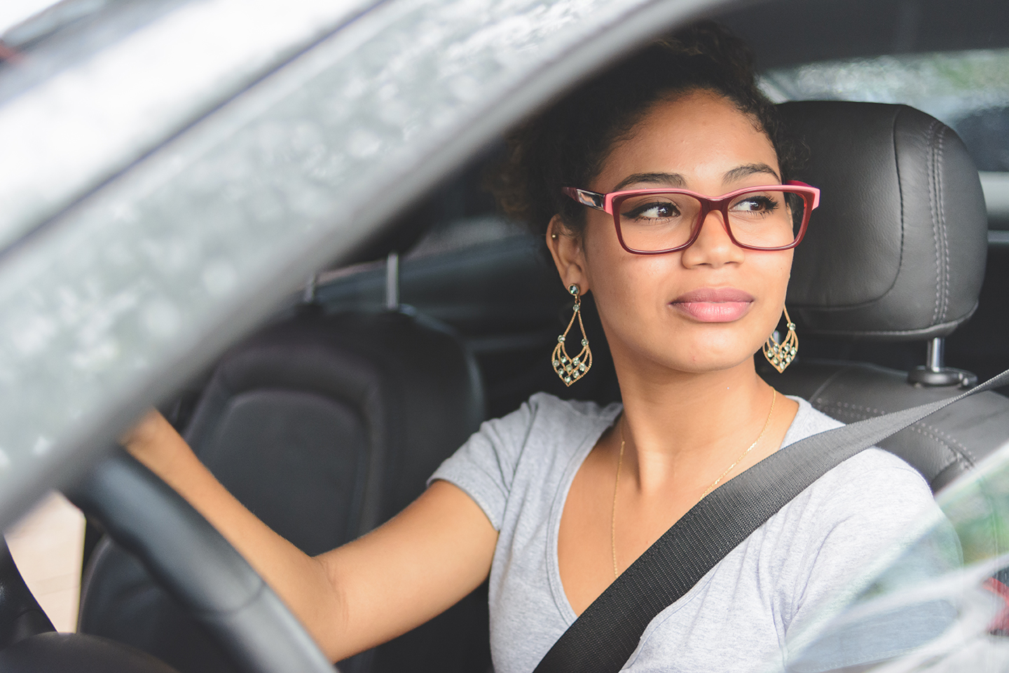 Portrait of young woman driving a car