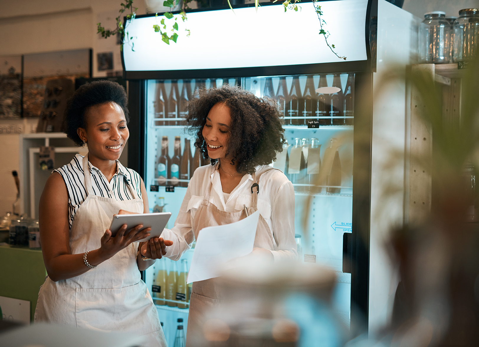 Shot of two young women using a digital tablet while doing inventory in a waste free store