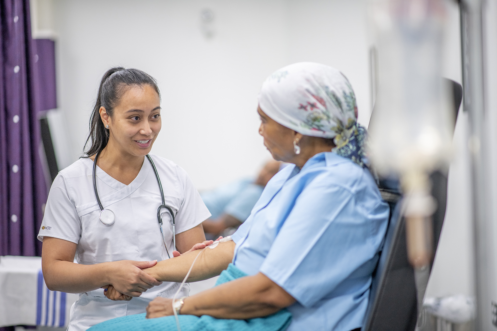 Senior adult woman in the oncology unit receiving chemotherapy treatment.