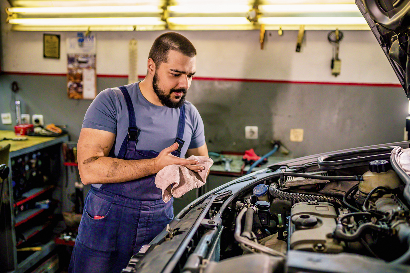 Professional mechanic repairing a car in auto repair shop