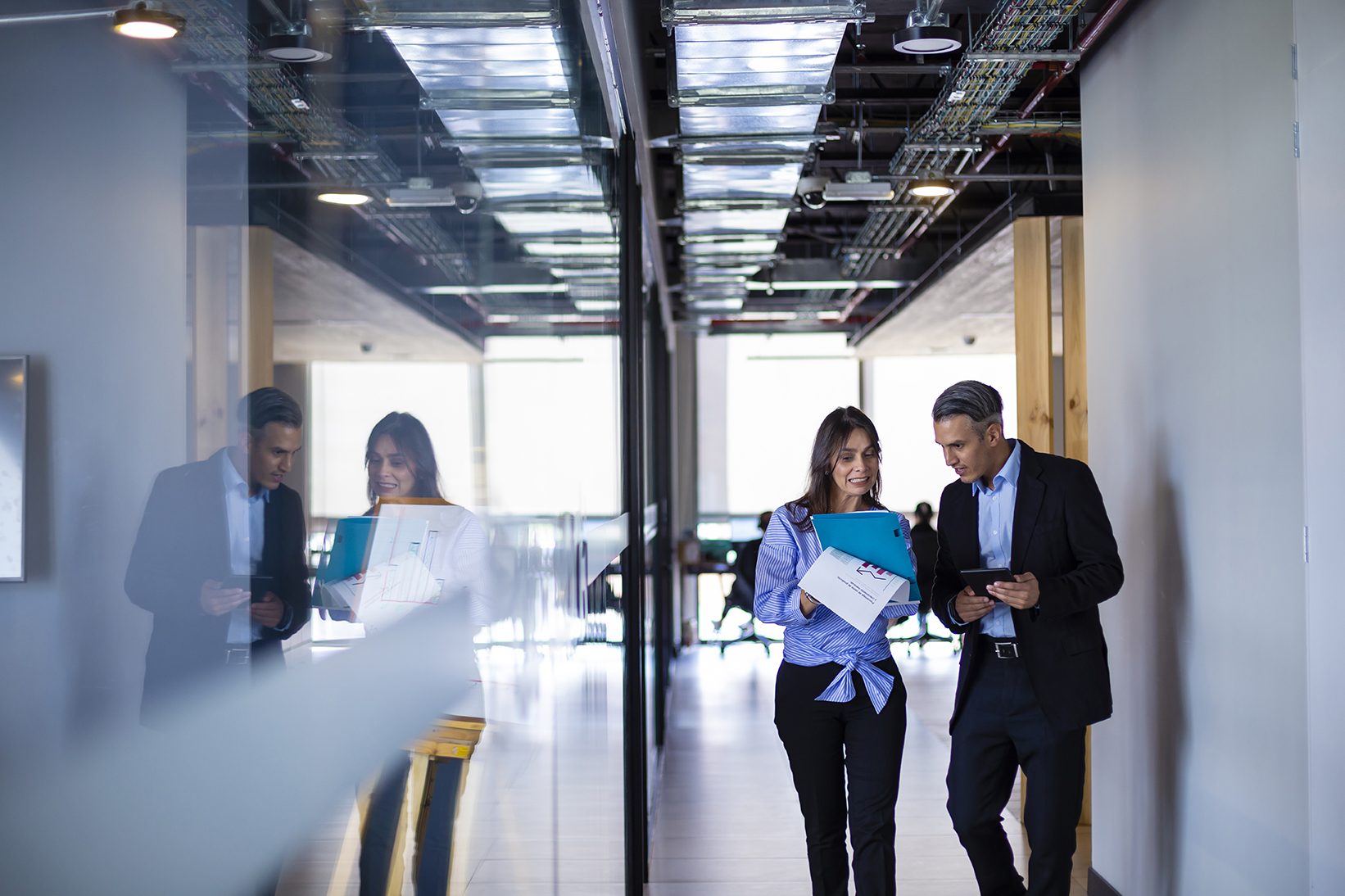 Business people walking and discussing something about their work at the office