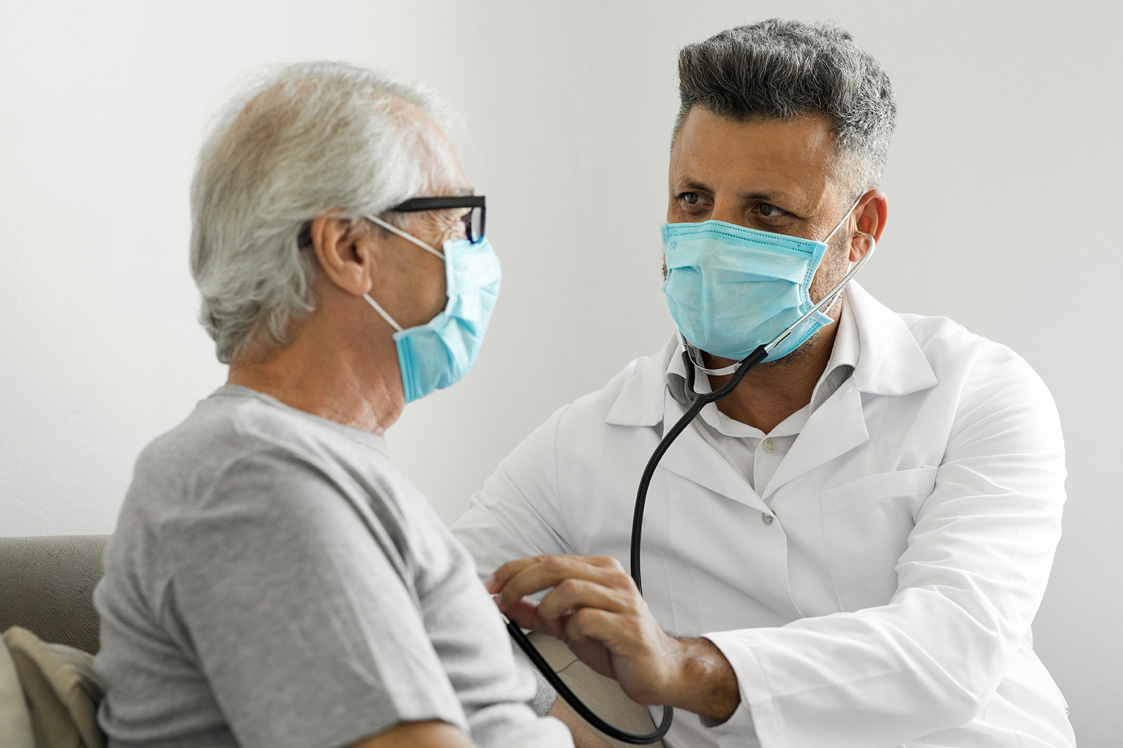 Health visitor and a senior man during home visit