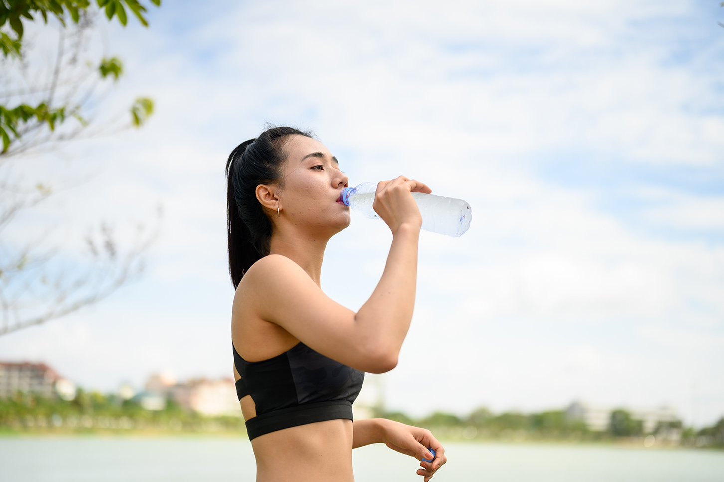 Women wearing black clothes to drink water while walking and running.