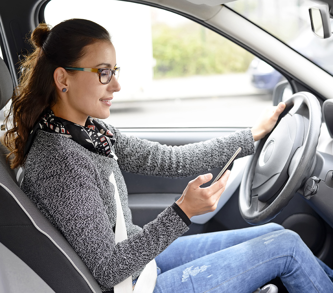 businesswoman writing message in the car