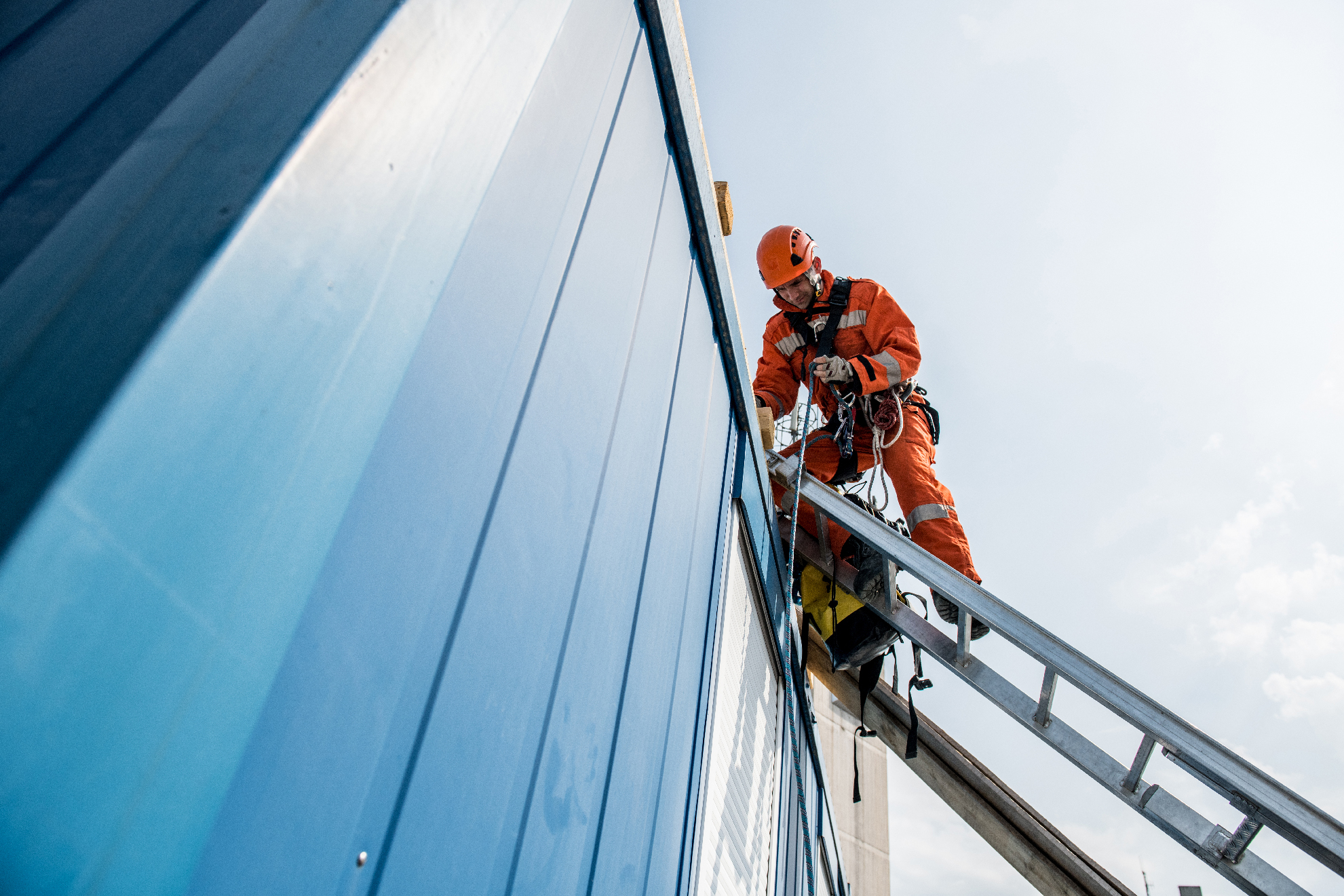 Firefighters in a rescue operation - accident on the roof; all logos removed. Slovenia, Europe. Nikon.