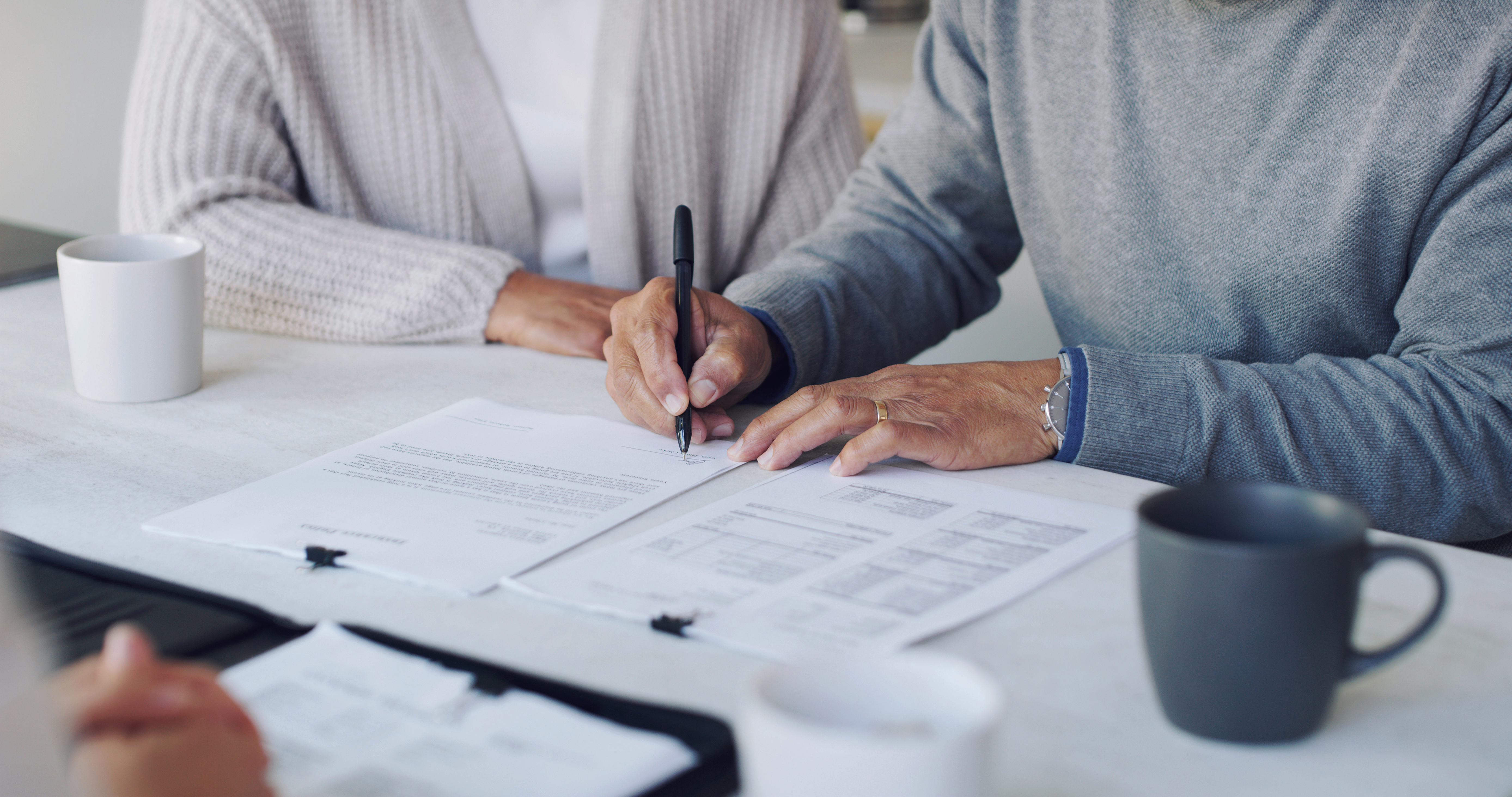 Cropped shot of a senior couple meeting with a consultant to discuss paperwork at home