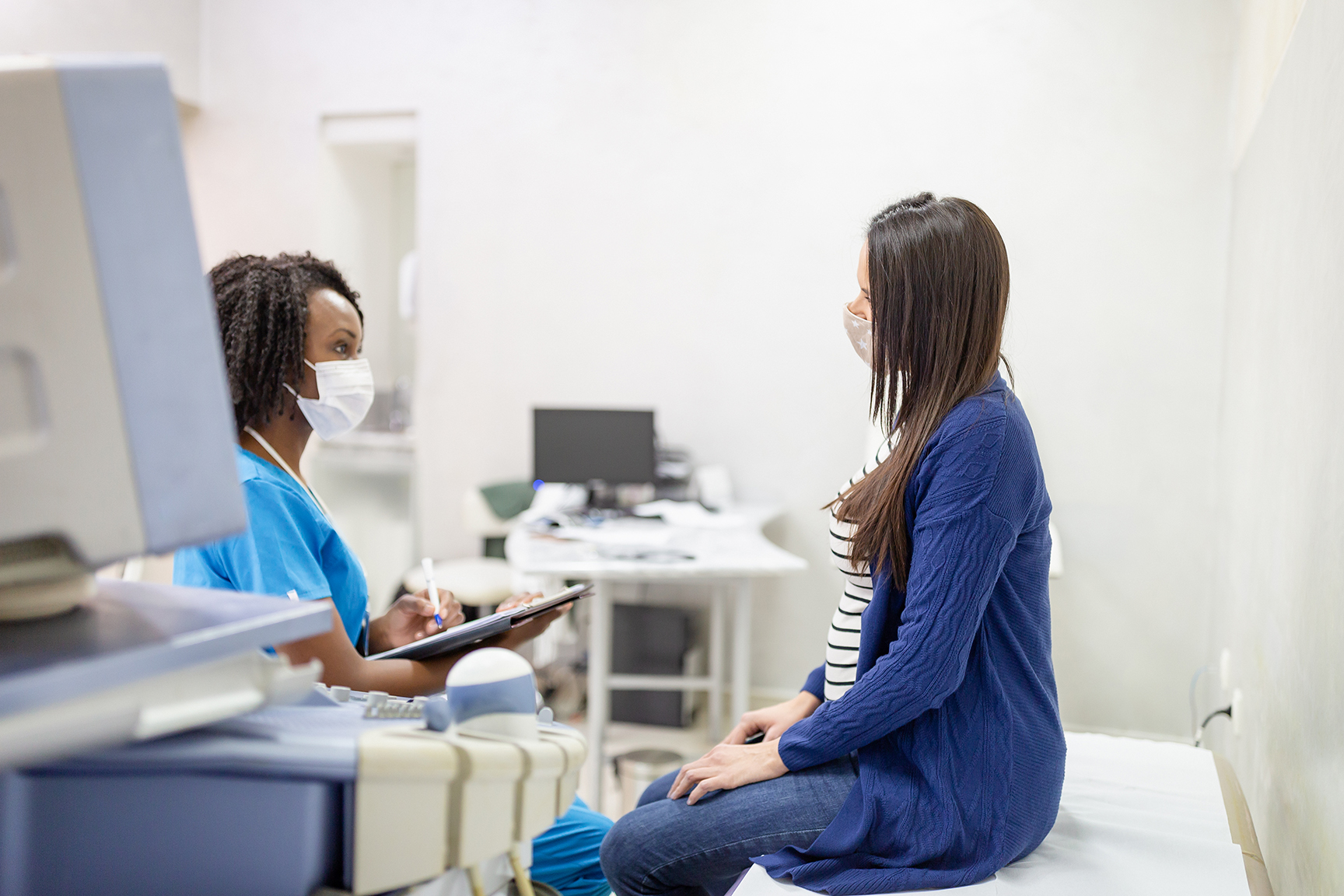 African-American female doctor doing gynecological examination