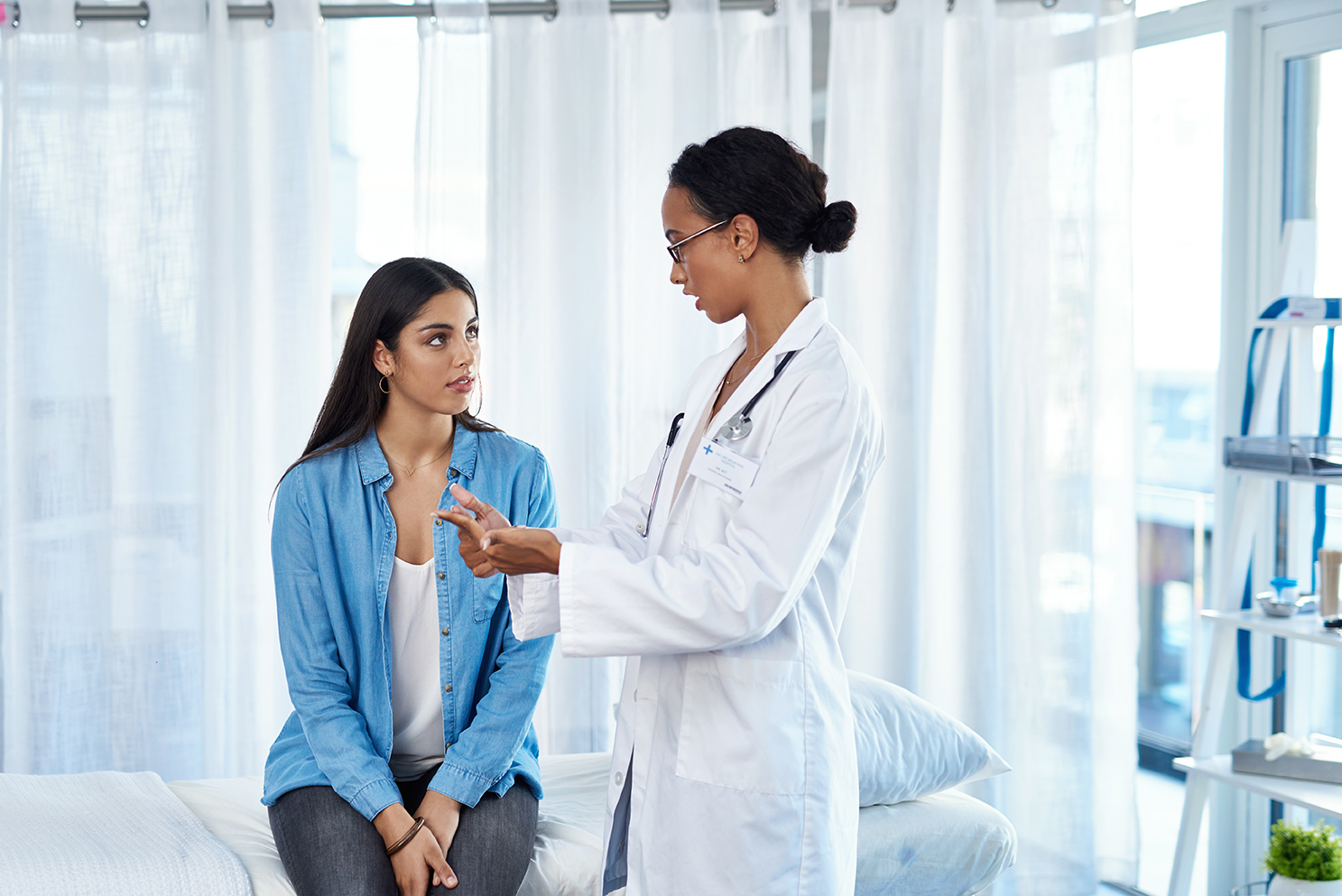 Shot of a young woman having a consultation with her doctor