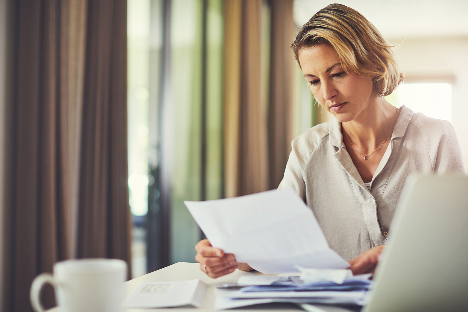 Shot of a mature woman going over her finances at home