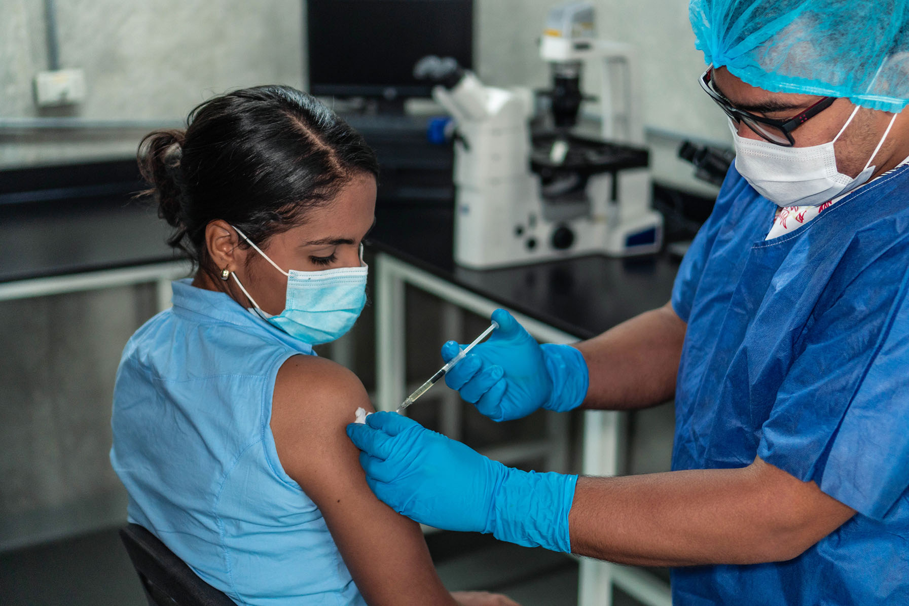 Hispanic woman receiving coronavirus vaccine