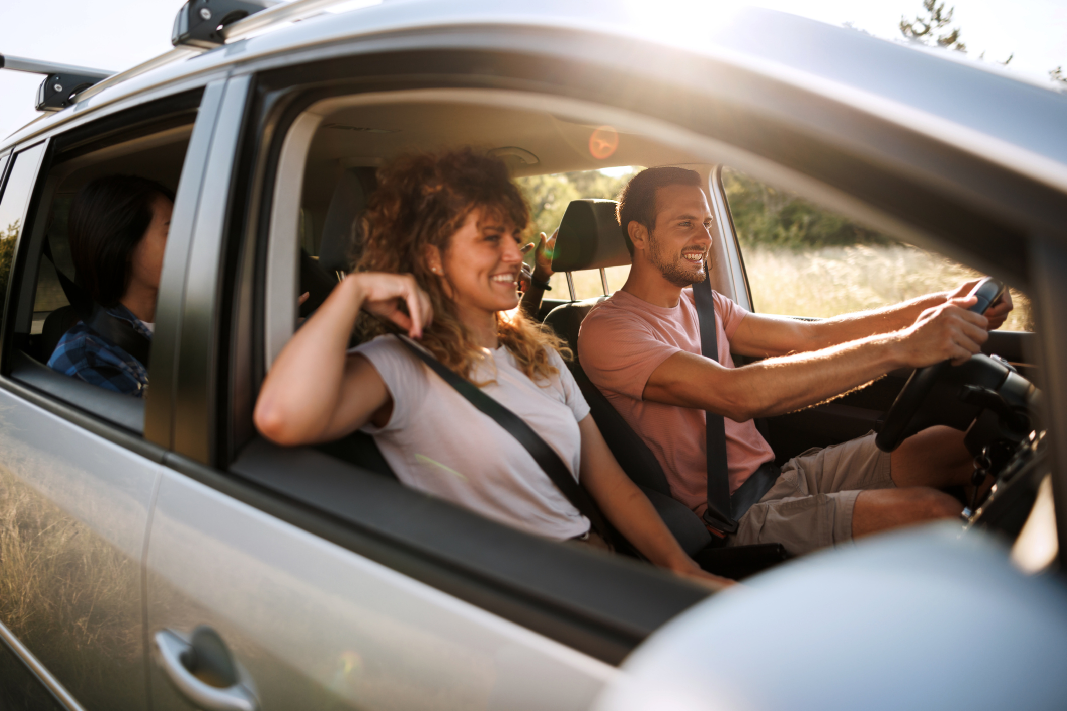 Young couple shares lighthearted moments and laughter during their adventurous car journey