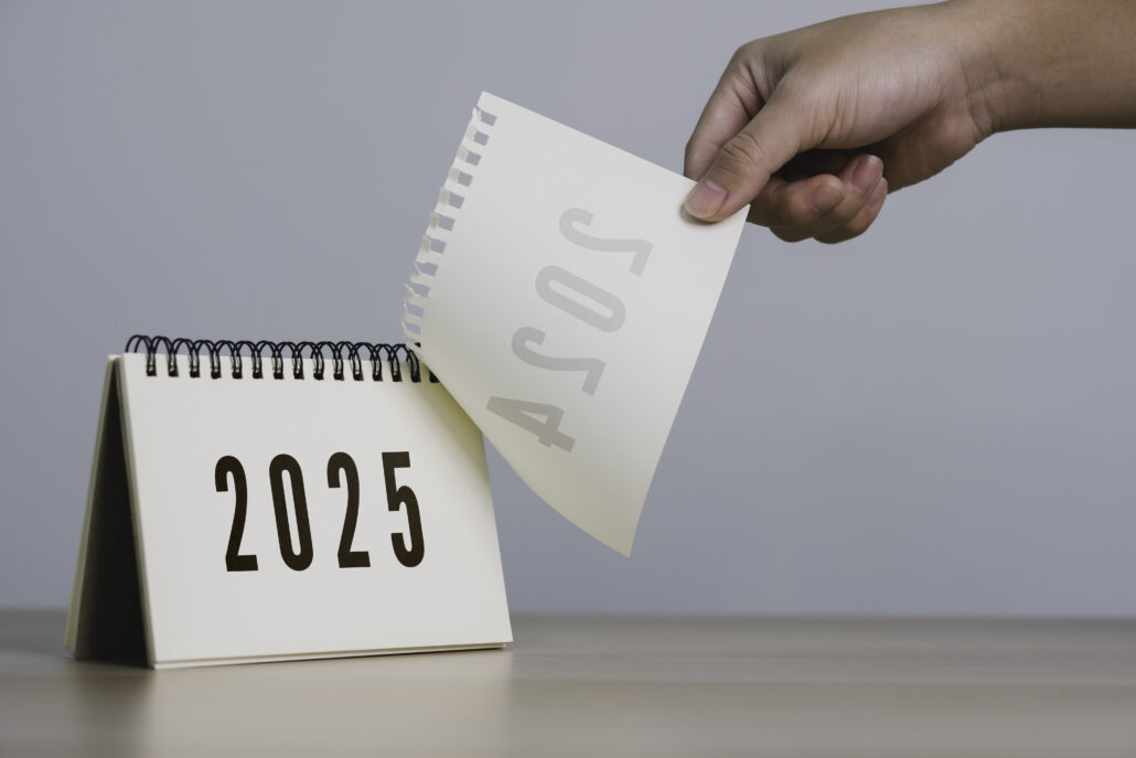 A person's hand is pulling a calendar from 2024 to 2025. 2025 Happy New year background. Setup objective target business cost and budget planning of new year concept.