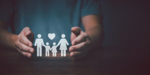 Father hands holding and protect family for safety life.