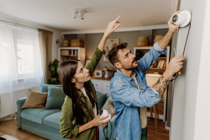 Young couple assembling her security system